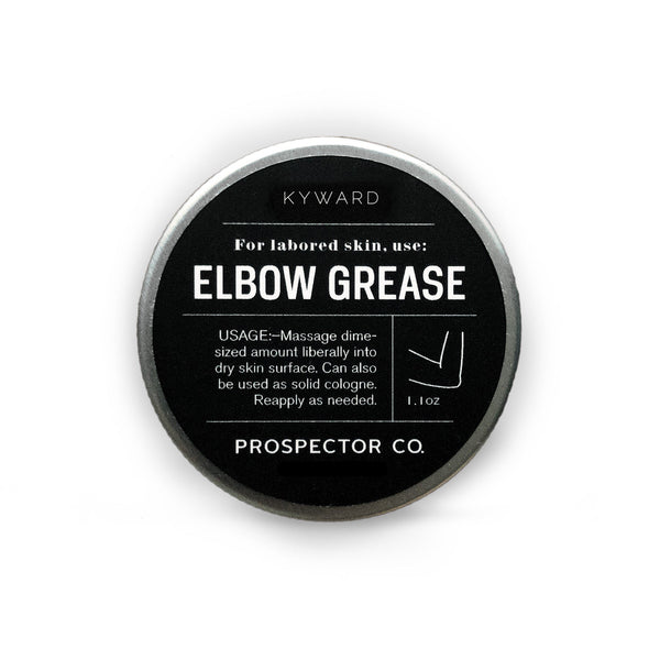 A circular metal tin of product with silver cap and black-colored ingredients label.